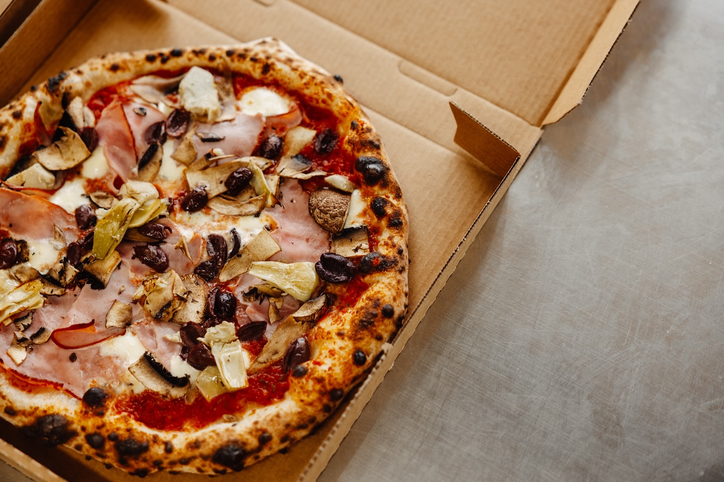 Fresh pizza in a takeaway box